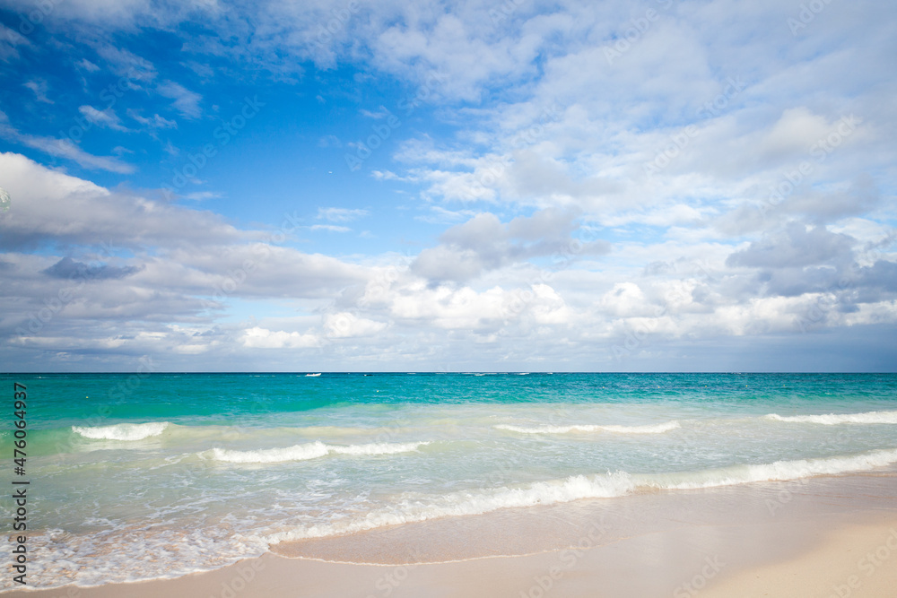 Coastal Caribbean landscape with empty sandy coast and waves