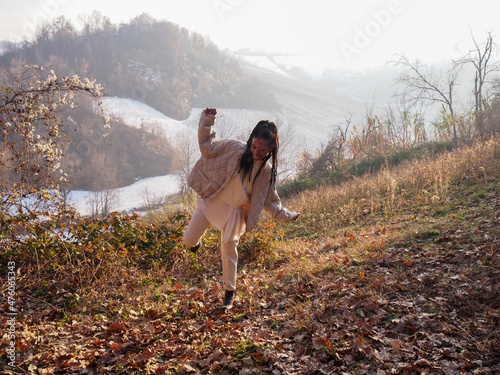 elegant active african american 20s girl walking and relaxing in a park in the snwed mountains in winter photo