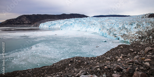 Landscape: Eqi glacier blue with blue ocean and rocks, Greenland 