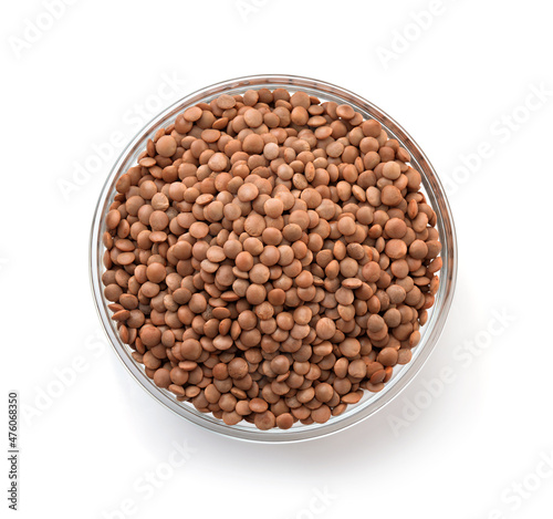Top view of dry brown lentils in glass bowl