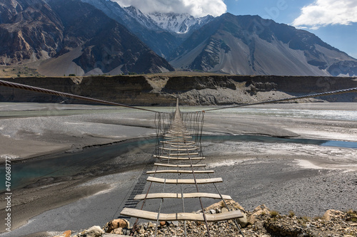 Suspension bridge passu cones mountain range rocky scenery. High quality photo