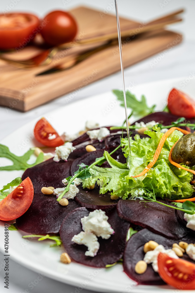 delicious beetroot carpaccio with feta, vertical image. top view. place for text delicious beetroot carpaccio with feta, vertical image. top view. place for text