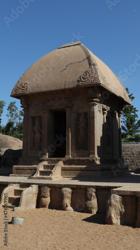 This is "five rathas" as they resemble the processional chariots of a temple. Statues carved in rock. this is one features in several Hindu scriptures. blue sky backgrounds