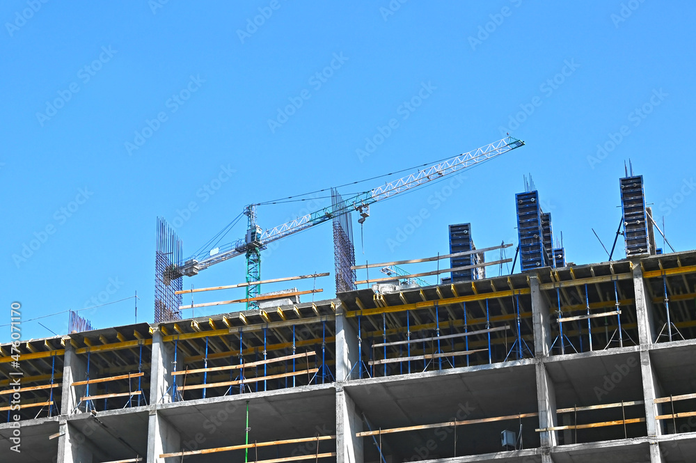 Crane and highrise construction site Crane and highrise construction site