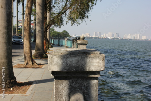 stone pillar on the fence near the lake