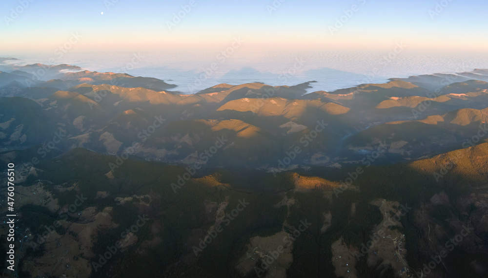 Beautiful mountain panoramic landscape with hazy peaks and foggy valley at sunset