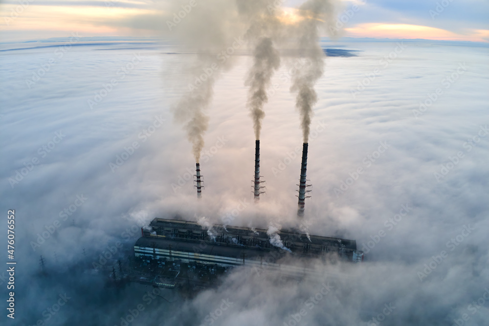 Obraz premium Coal power plant high pipes with black smoke moving upwards polluting atmosphere. Production of electrical energy with fossil fuel concept