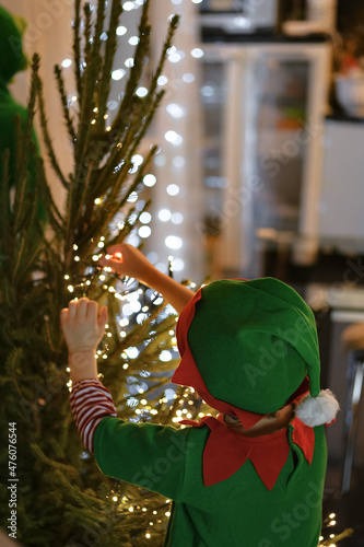 Little kids decorating Christmas tree at home