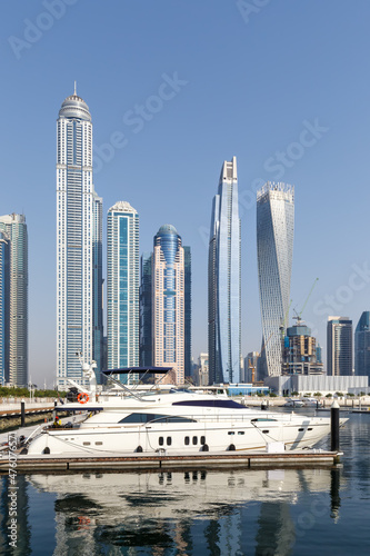 Dubai Marina and Harbour skyline architecture wealth luxury travel in United Arab Emirates with boat yacht portrait format © Markus Mainka