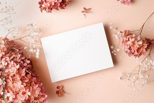 Fototapeta Wedding invitation or greeting card mockup with hydrangea and gypsophila flowers decorations