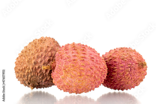 Three ripe organic litchi fruit, close-up, isolated on white.