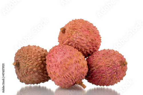Several ripe organic litchi fruit, close-up, isolated on white.