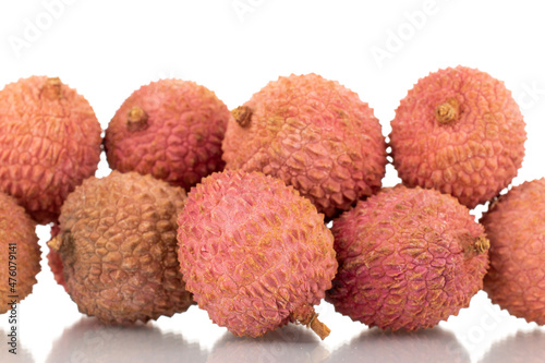 Several ripe organic litchi fruit, close-up, isolated on white.