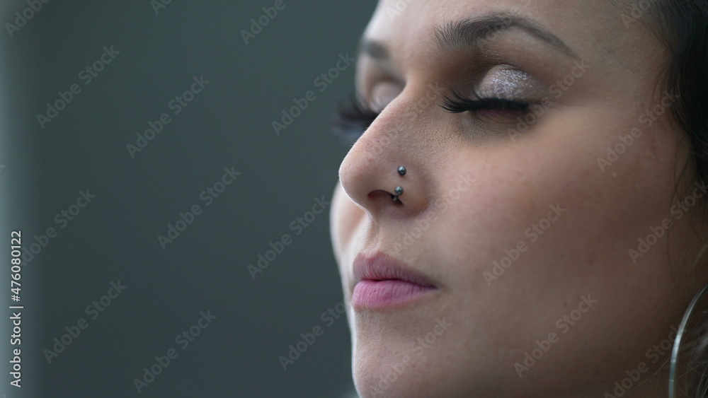 Young woman closing eyes in meditation, person opening eye to sky smiling Young woman closing eyes in meditation, person opening eye to sky smiling