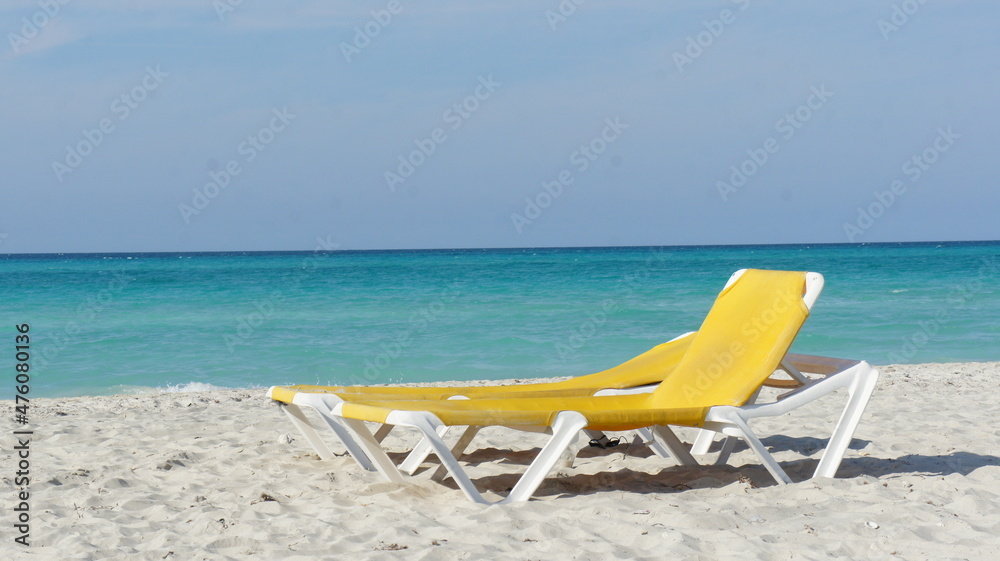 Cuba, February 2012, yellow sun lounger on a white sand beach against the backdrop of a turquoise sea Cuba, February 2012, yellow sun lounger on a white sand beach against the backdrop of a turquoise sea