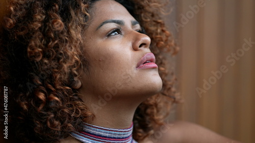 Pensive black woman leaning on wall thinking about life. Thoughtful person