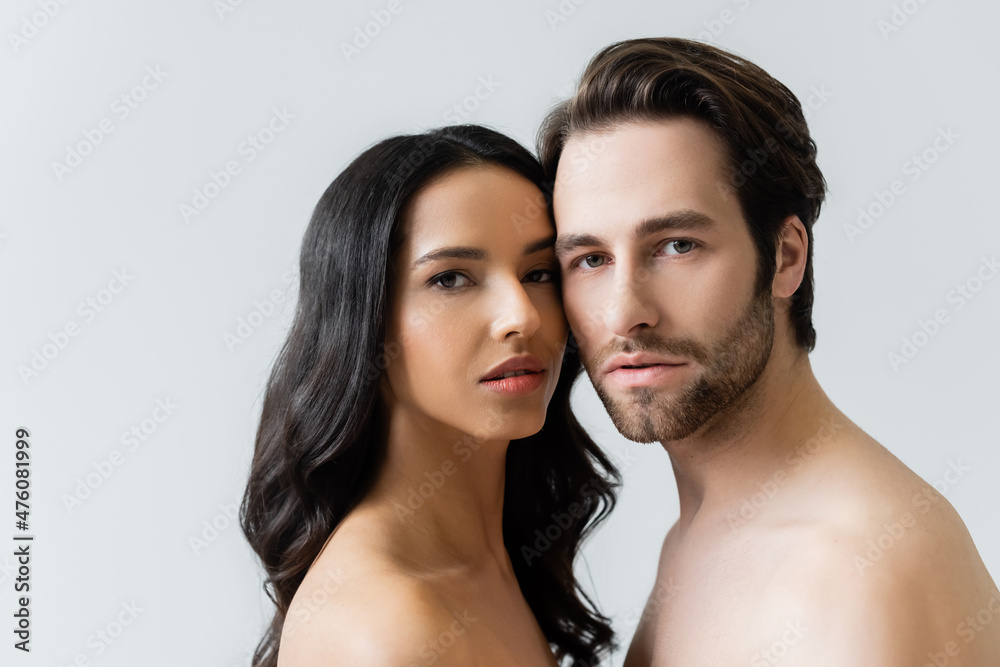 naked man and woman looking at camera isolated on grey. naked man and woman looking at camera isolated on grey.