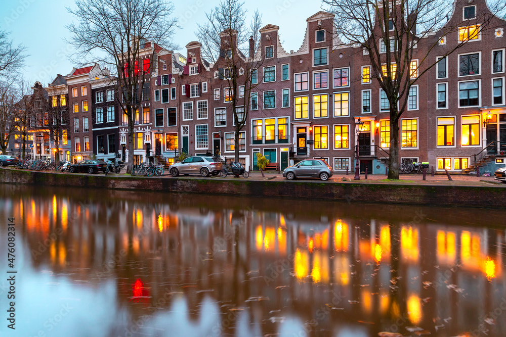Evening Amsterdam canal Leidsegracht with typical dutch houses at gold hour, Holland, Netherlands.