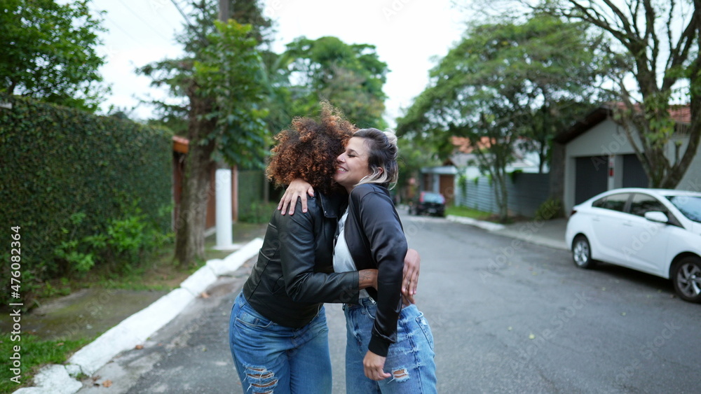Fototapeta premium Friends embrace, two women hug, diversity concept