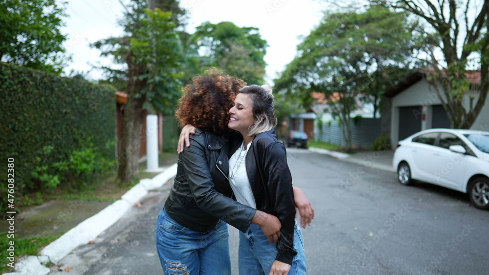 Friends embrace, two women hug, diversity concept Friends embrace, two women hug, diversity concept