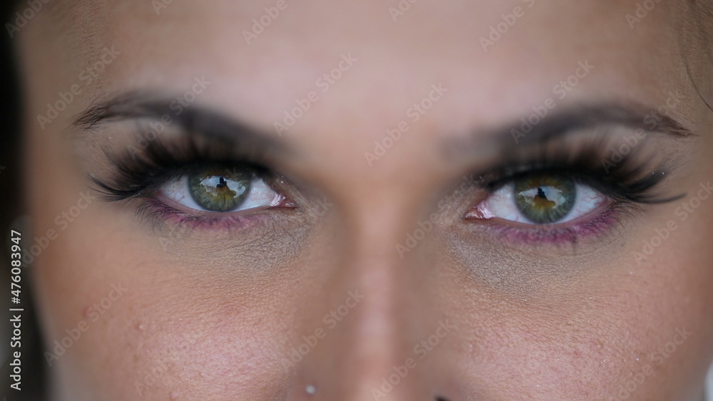 Woman green eyes looking at camera macro close-up Woman green eyes looking at camera macro close-up