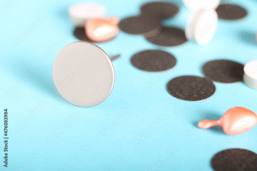 a metal disc for the treatment of feet in a pedicure lies on a bright background a metal disc for the treatment of feet in a pedicure lies on a bright background
