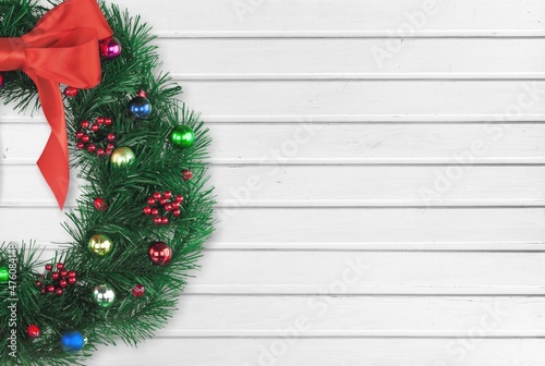 Christmas wreath with decorations on a wooden background