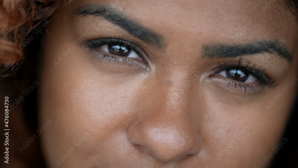 Fototapeta premium Hispanic black woman macro eyes close-up face looking at camera
