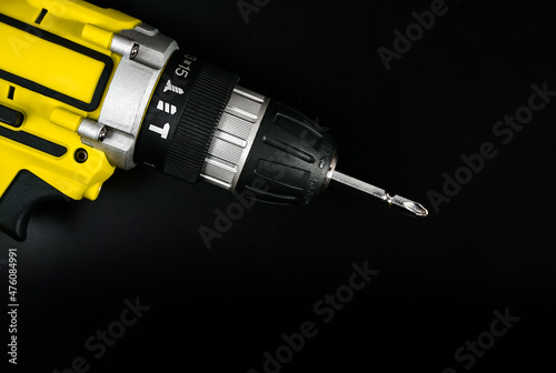 cordless electric screwdriver drill on black background, professional home repair tool, hand power tool, copy space, mock up, design. 