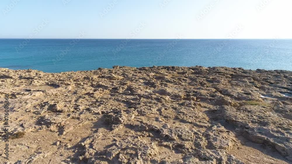 Aerial landscape at the edge of the earth, Turquoise calm sea waves beat against a rocky cliff, Ocean breeze, purity and untouched nature, Geological wonder, Cyprus Aerial landscape at the edge of the earth, Turquoise calm sea waves beat against a rocky cliff, Ocean breeze, purity and untouched nature, Geological wonder, Cyprus