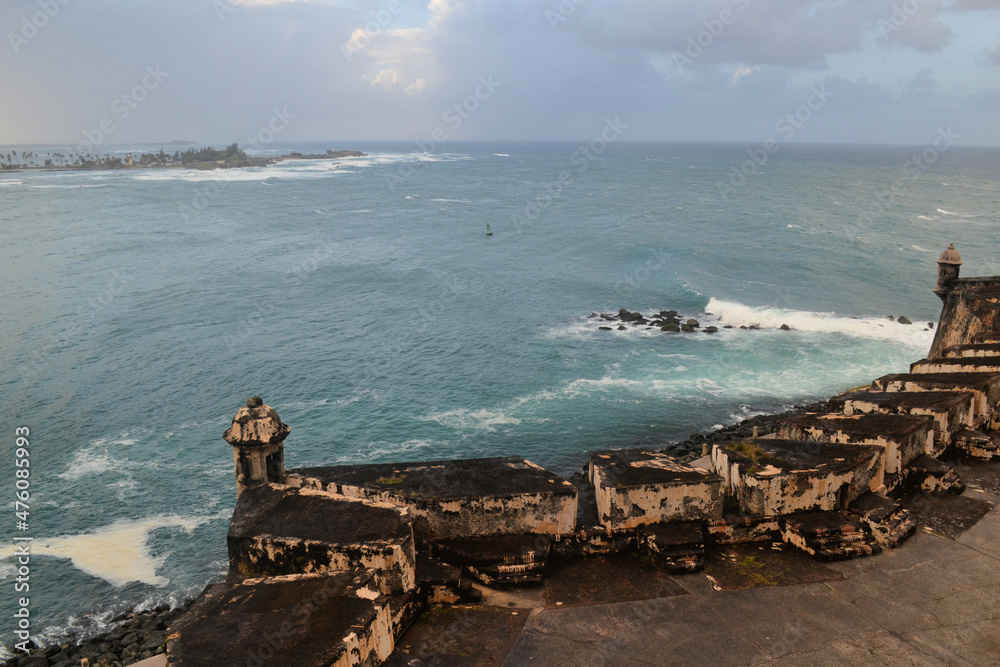 Stormy ocean and cloudy sky with old fortification wall, view from Castillo San Felipe del Morro, Old San Juan Puerto Rico