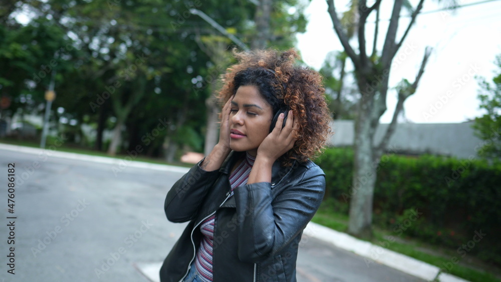 Black woman laughing and smiling, person spontaneous laugh and smile wearing headphone Black woman laughing and smiling, person spontaneous laugh and smile wearing headphone