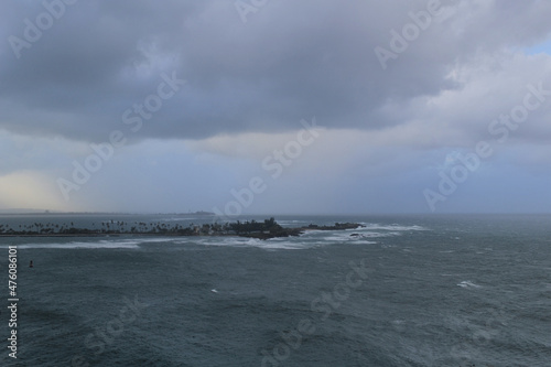 Stormy ocean with cloudy sky, with island in a background, view from Castillo San Felipe del Morro, Puerto Rico