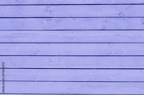 Surface of wooden boards painted with lilac paint. Wooden background painted trendy color of the year 2022 Very Peri.