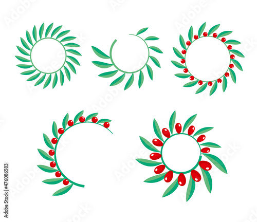 Green wreath with red berries on white background
