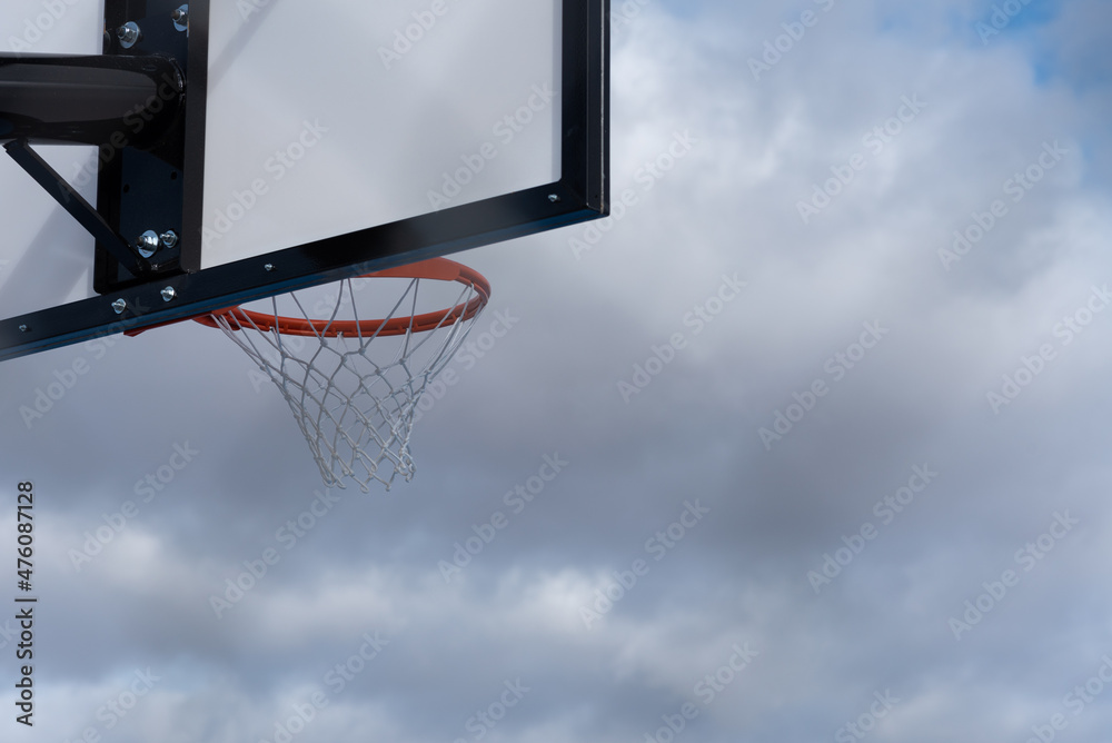Basketball hoop against cloudy sky