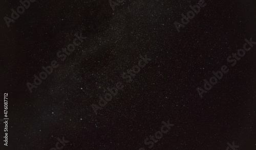 Night sky with in area near constellation Andromeda, five distinct stars forming Cassiopeia visible in lower left