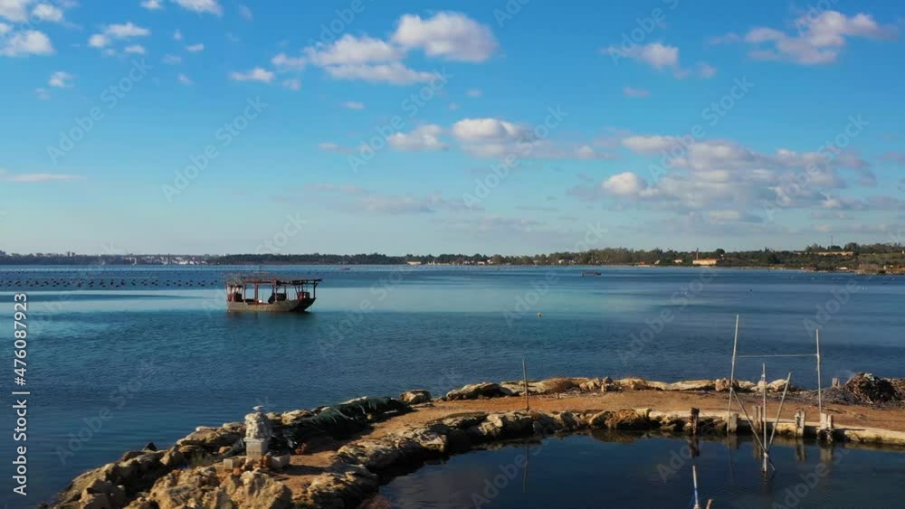 Small pier with boats for collecting mussels in the Piccolo sea of Taranto Small pier with boats for collecting mussels in the Piccolo sea of Taranto