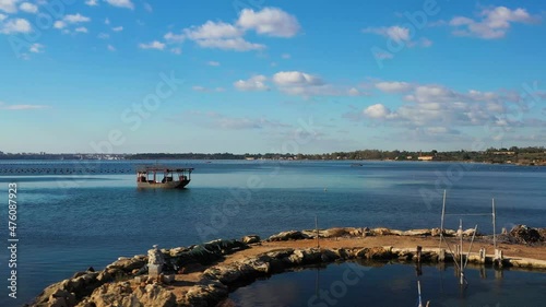 Small pier with boats for collecting mussels in the Piccolo sea of ​​Taranto