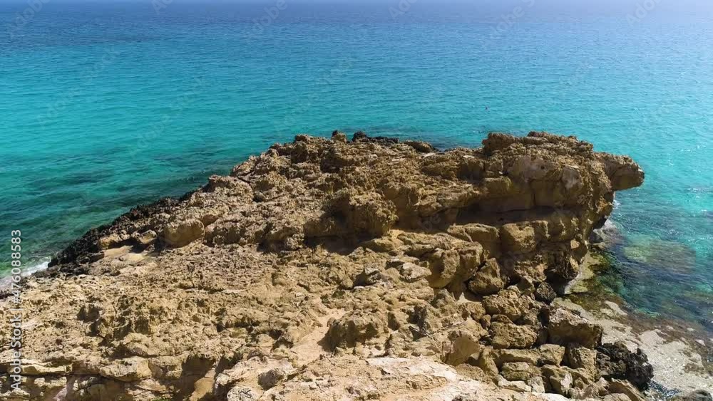 Aerial landscape at the edge of the earth, Turquoise calm sea waves beat against a rocky cliff, Ocean breeze, purity and untouched nature, Geological wonder, Cyprus Aerial landscape at the edge of the earth, Turquoise calm sea waves beat against a rocky cliff, Ocean breeze, purity and untouched nature, Geological wonder, Cyprus