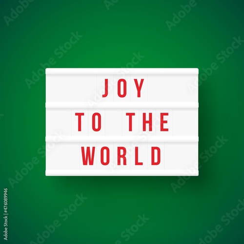 Christmas quote on a light box letter sign with green background: Joy to the world.