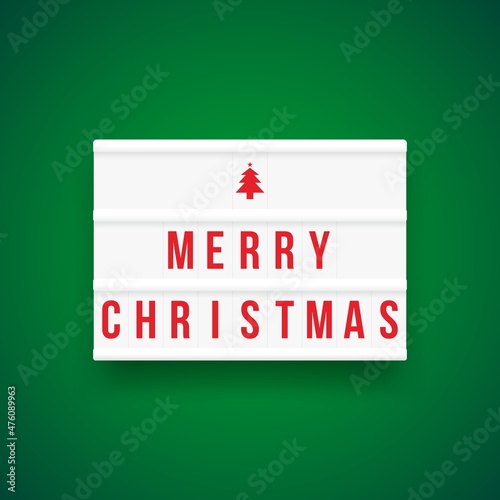 Christmas quote on a light box letter sign with green background: Merry Christmas.