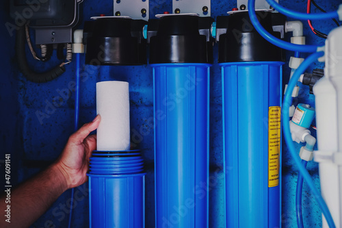 Water filter system or osmosis, Replacing the water filter, water-purification. Commercial use. Selective focus.