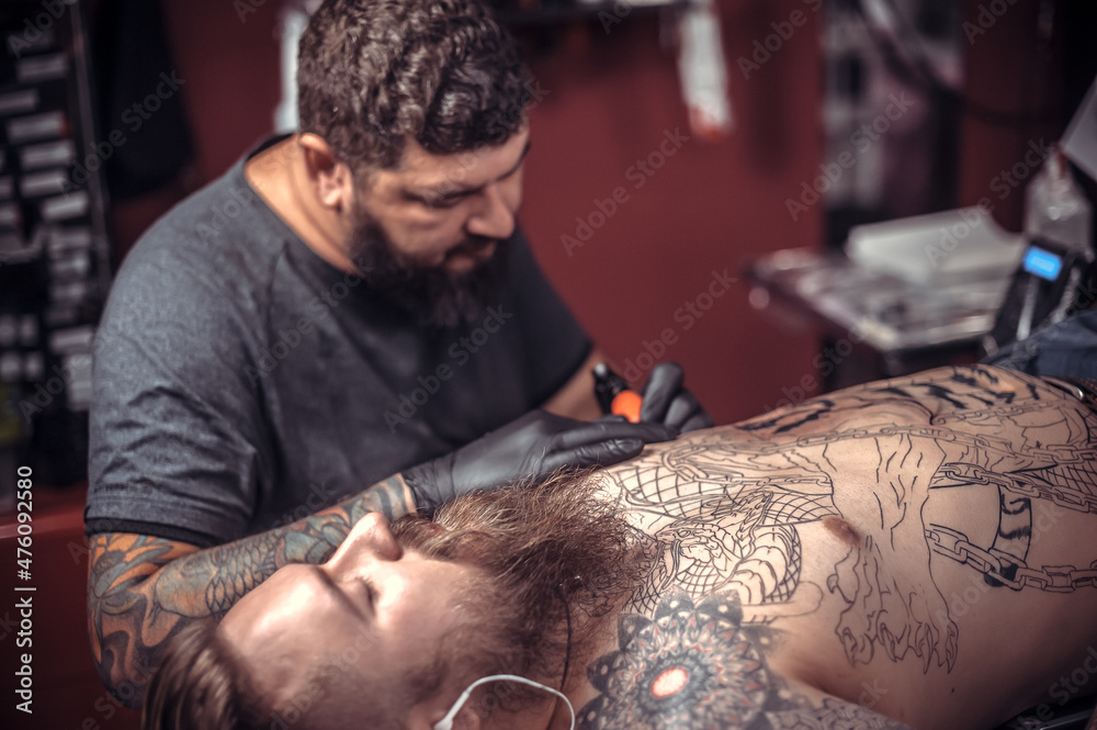 © Mr. Prof - Professional tattooer showing process of making a tattoo