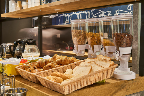 Cereals, bread and croissants in the breakfast area photo