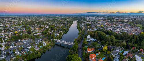 Aerial drone panoramic view at sunset, looking up the Waikato River towards the CBD, over the city of Hamilton (Kirikiriroa) in the Waikato region of New Zealand. photo