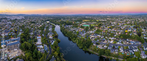 Aerial drone panoramic view at sunset, looking North down the Waikato River, over the city of Hamilton (Kirikiriroa) in the Waikato region of New Zealand.