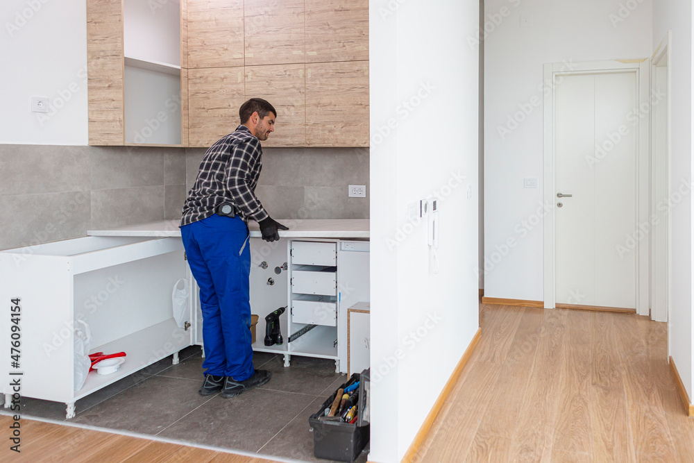 A carpenter sets up a working surface in the kitchen