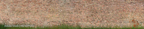 Fotografie, Obraz medieval sandstone wall with grass at the boddom