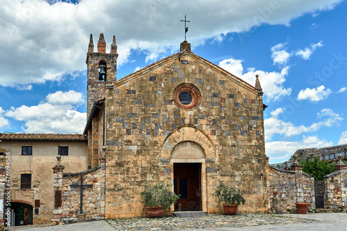 Stone, medieval church with a bell tower in the village of Monteriggioni in Toscana photo